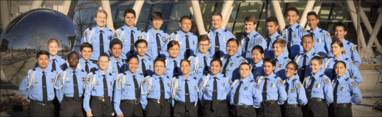 group of teenagers wearing blue shirts with explorer patches on sleeve