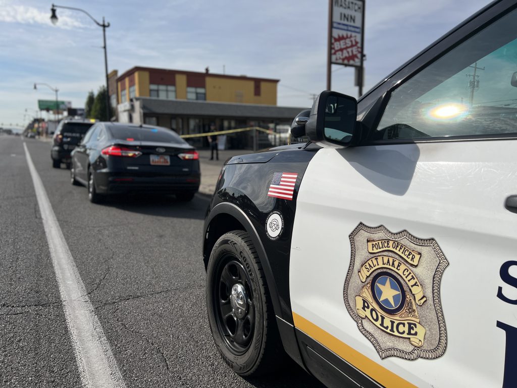 A picture of a police car with crime scene tape in the background