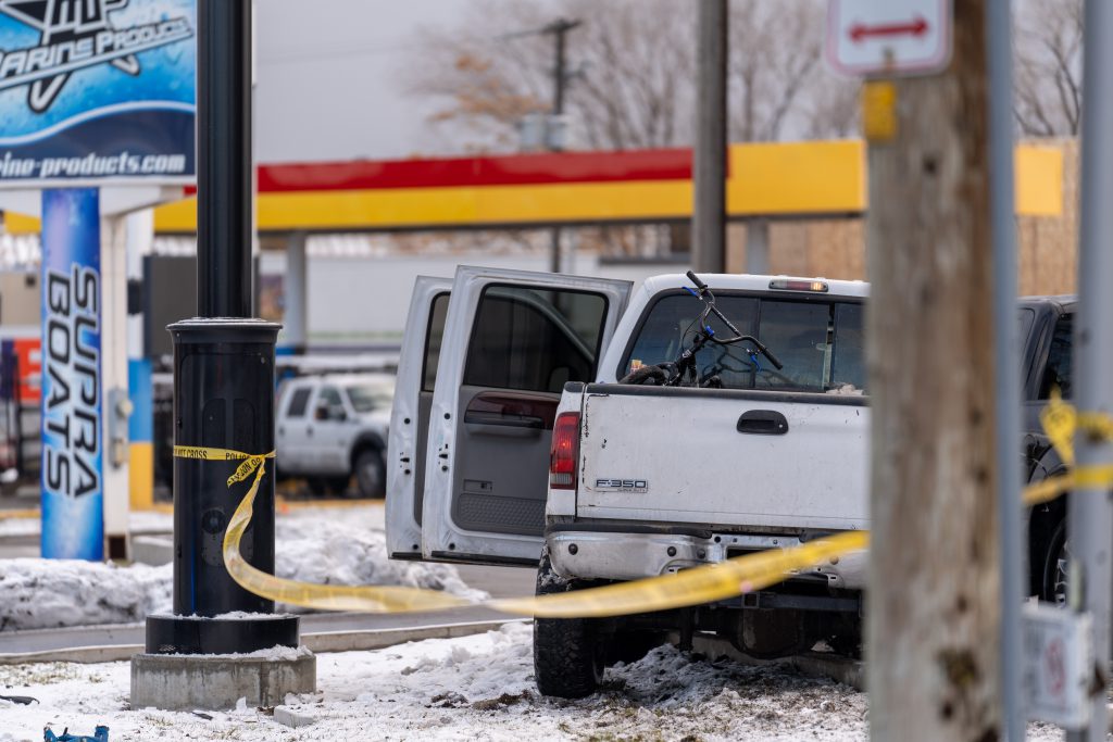 A photo of a white truck with its driver side doors open.