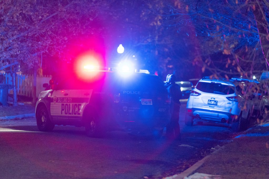 Phot of police car with emergency lights on.