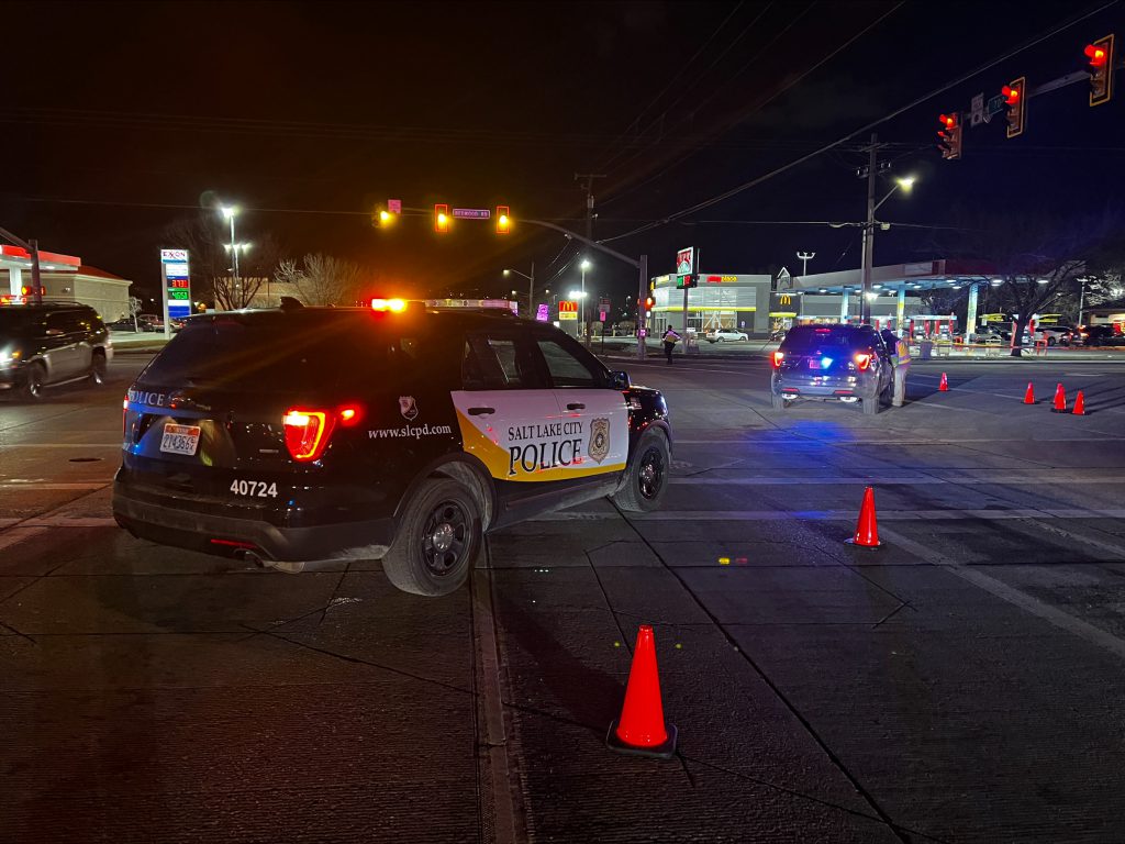 A SLCPD police SUV blocking the intersection of a deadly crash on Redwood Road.