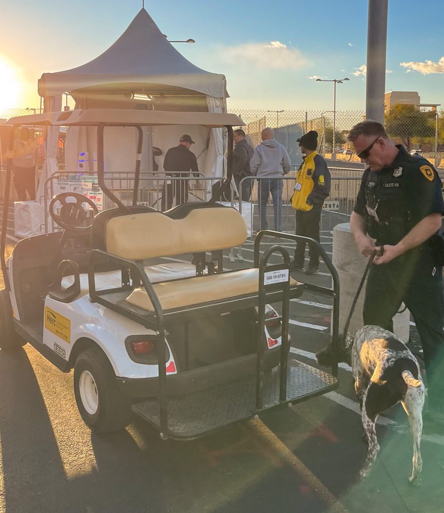 Photo of a police officer and his K-9 working.