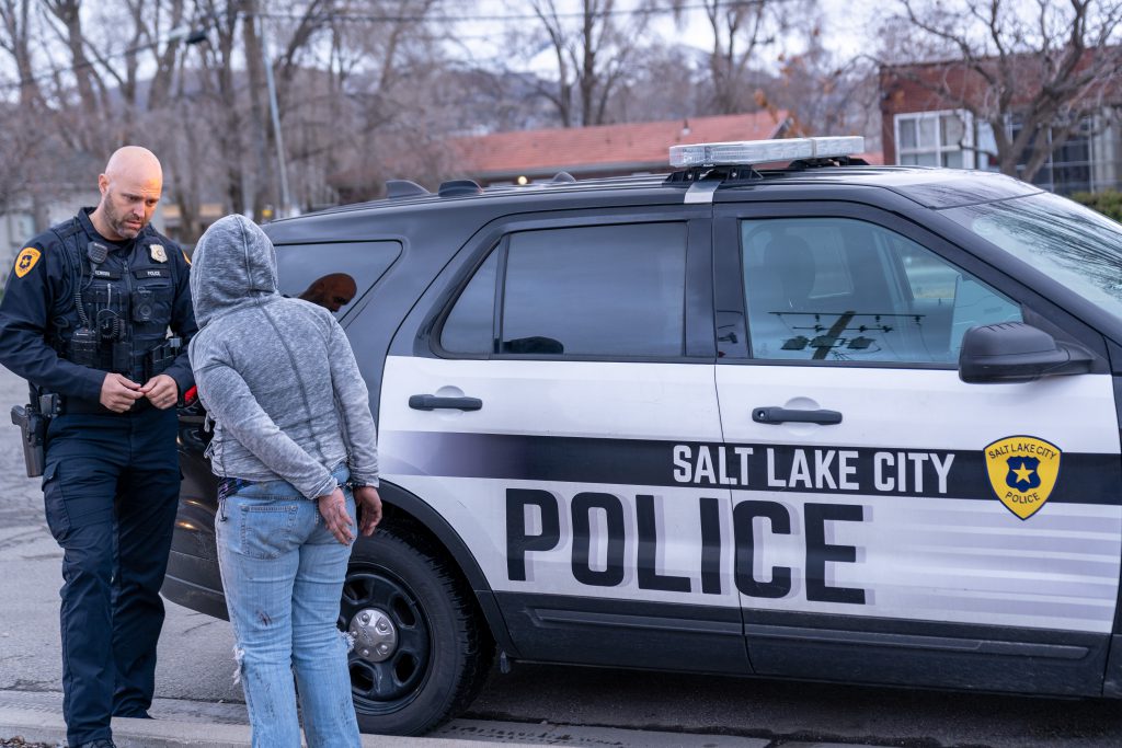 A Salt Lake City police officer talking to a woman he arrested.