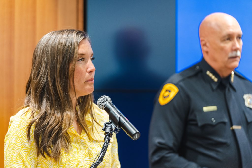 Mayor Erin Medenhall answers questions of a reporter at a news conference.