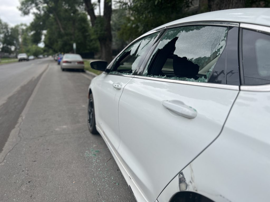 A car parked with two broken windows