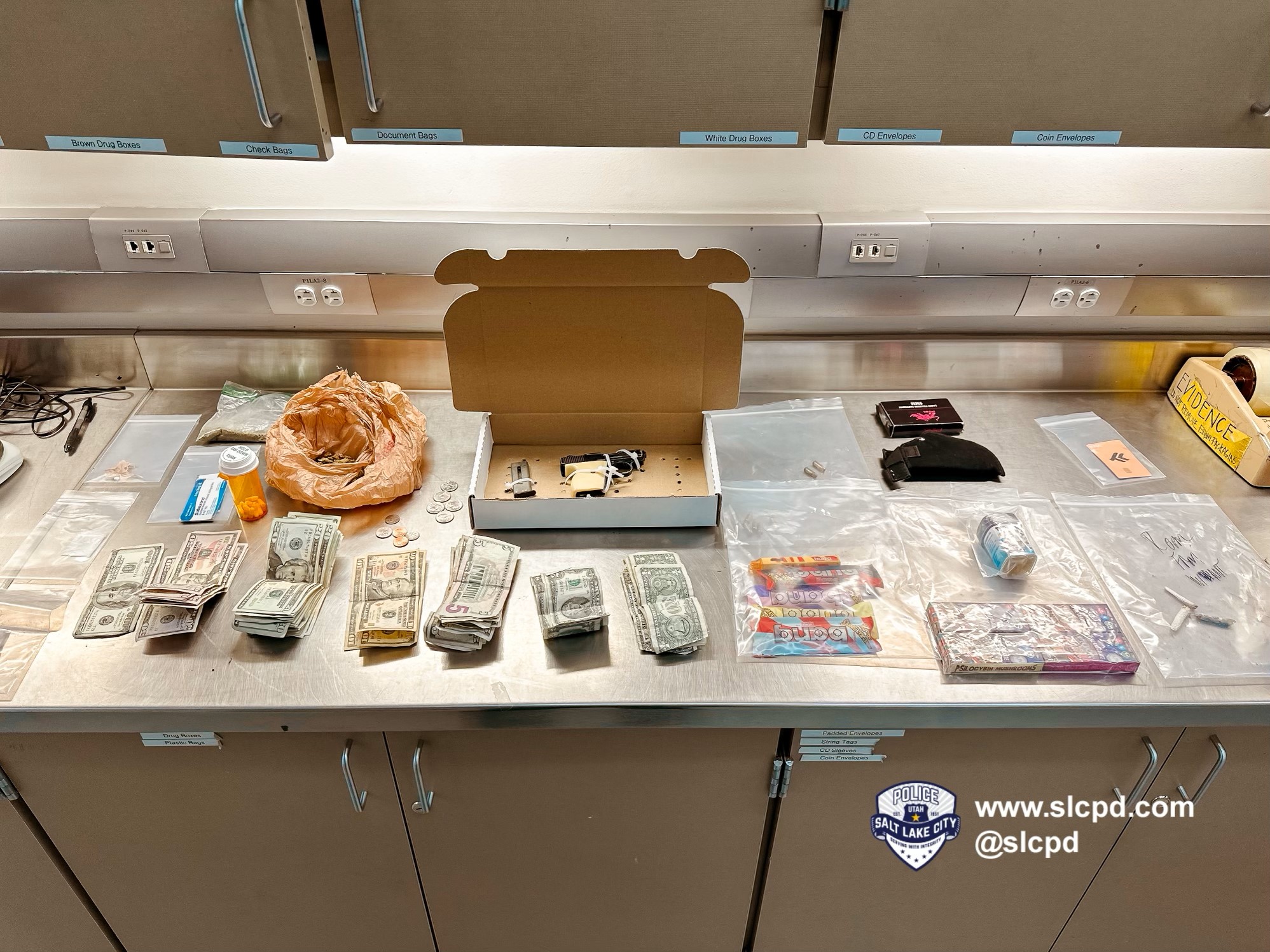 A handgun, drugs and cash recovered by police during a traffic stop