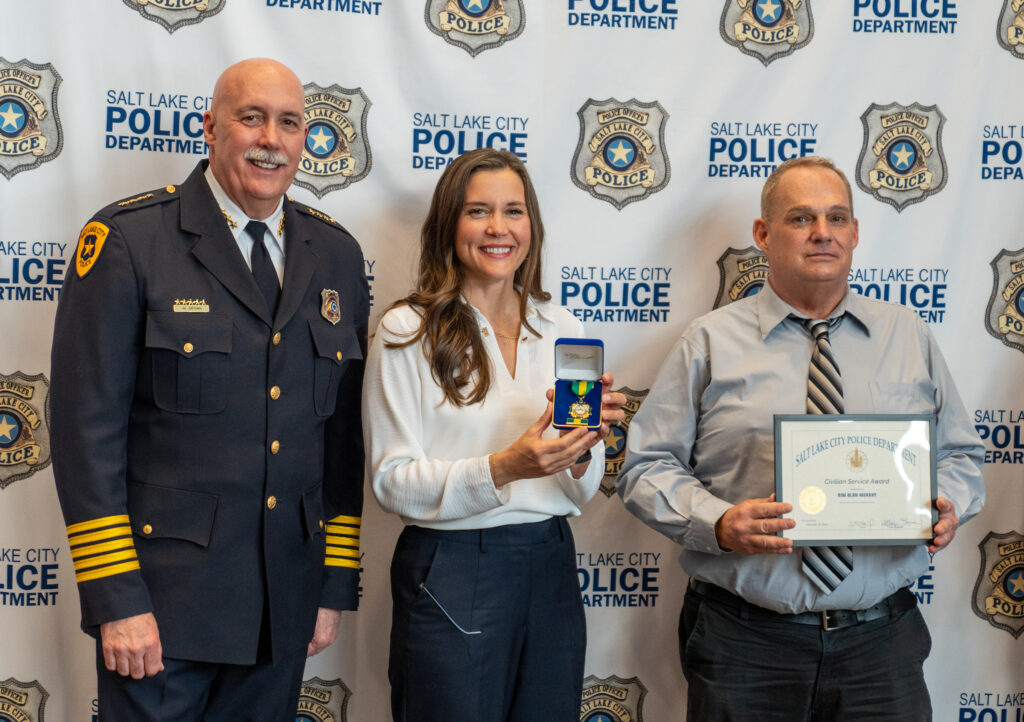 Mayor Erin Mendenhall and Chief Mike Brown award Kim Alan Murray the Partner in Public Safety Award